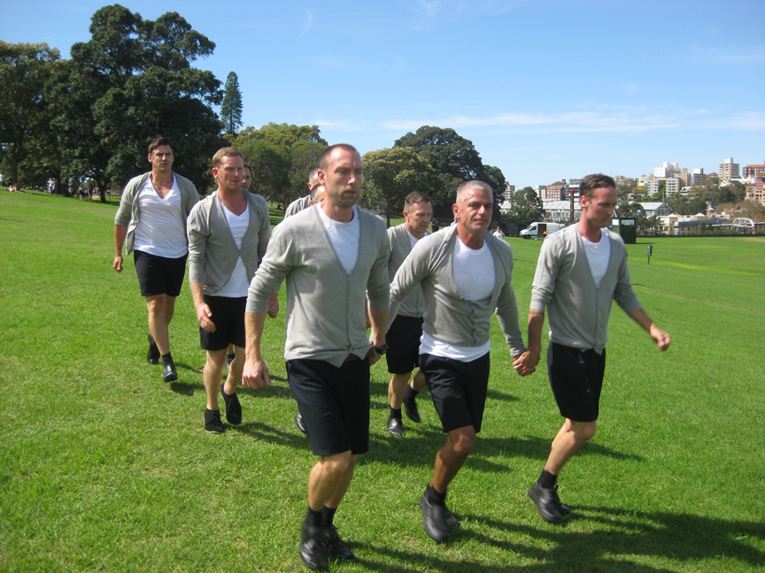 Eglë Budvytytë’s Choreography for the Running Male (2012) rewards visitors who take the trouble to seek out the open-air performances with 16 running—at times crawling—men moving in unison through the streets and parks of Sydney. It is a humorous comment on how we unconsciously adopt stereotypical behaviors when brought together as a group.