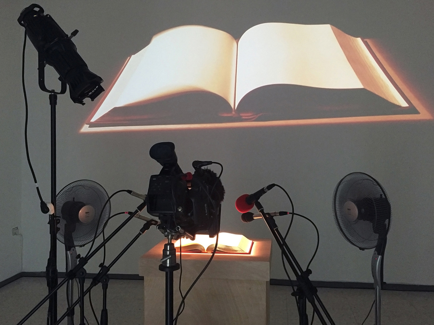 NIDA SINNOKROT, Exquisite Rotation, 2016, two oscillating fans, pedestal, speakers, projector, camera, tripod and microphones, dimensions variable. Installation view at Birzeit University, Qalandiya International, 2016.