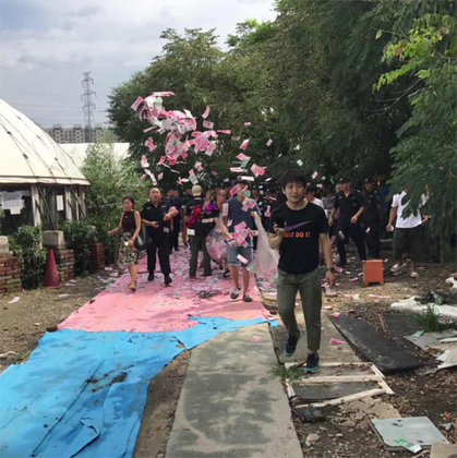 A “rainbow carpet” was set in place to prepare for the arrival of Chinese security officers. Some residents were handed what appears to be clear bags filled with cash, which they tossed into the air. Photo from Instagram.