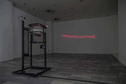 RALF BAECHER, Mirage, 2014, laser projection, aluminum profile, custom electronics, muscle wires, line laser module, flux-gate magnetometer, dimensions variable. Courtesy the artist.