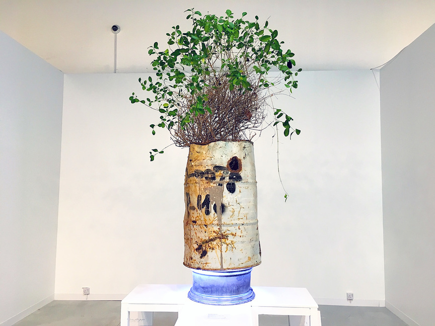 Emirati artist RAWDHA AL-KETBI’s assemblage, Transitional (2018), exploring issues of migration and made from a discarded oil barrel, car tire rim, found plant, and LED lights, at Zayed University College of Arts and Creative Enterprises (Abu Dhabi).