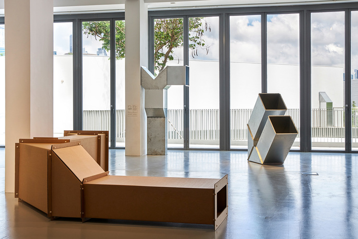 Installation view of CHARLOTTE POSENENSKE’s DW Vierkantrohre, 1967, corrugated cardboard, dimensions variable; and D Vierkantrohre, 1967, hot-dip galvanized sheet steel and screws, dimensions variable, at “Five Artists: Sites Encountered,” M+ Pavilion, Hong Kong, 2019. Courtesy M+, Hong Kong.